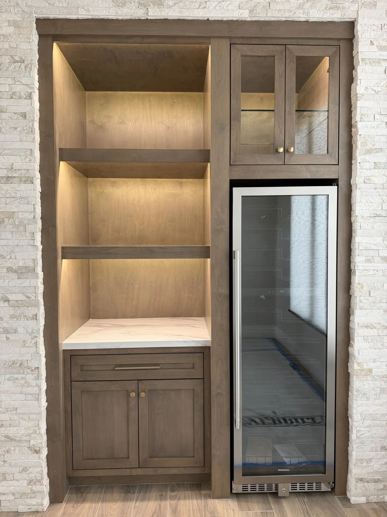 Built-in bar with under shelf lighting and wine fridge