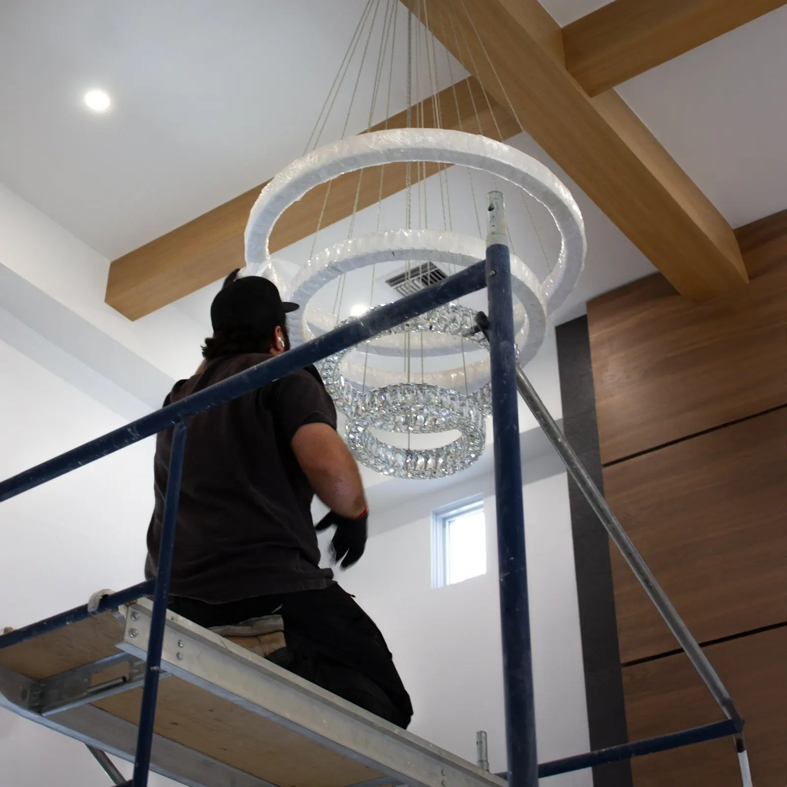 Crew prepping a chandelier for install