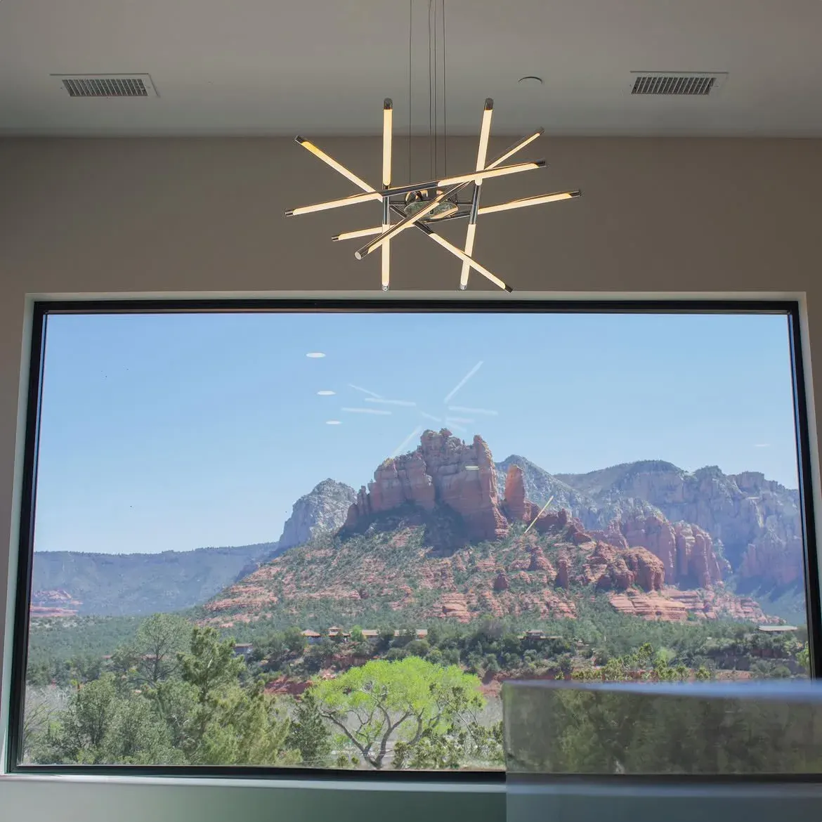 Chandelier install in a custom home overlooking mountain views