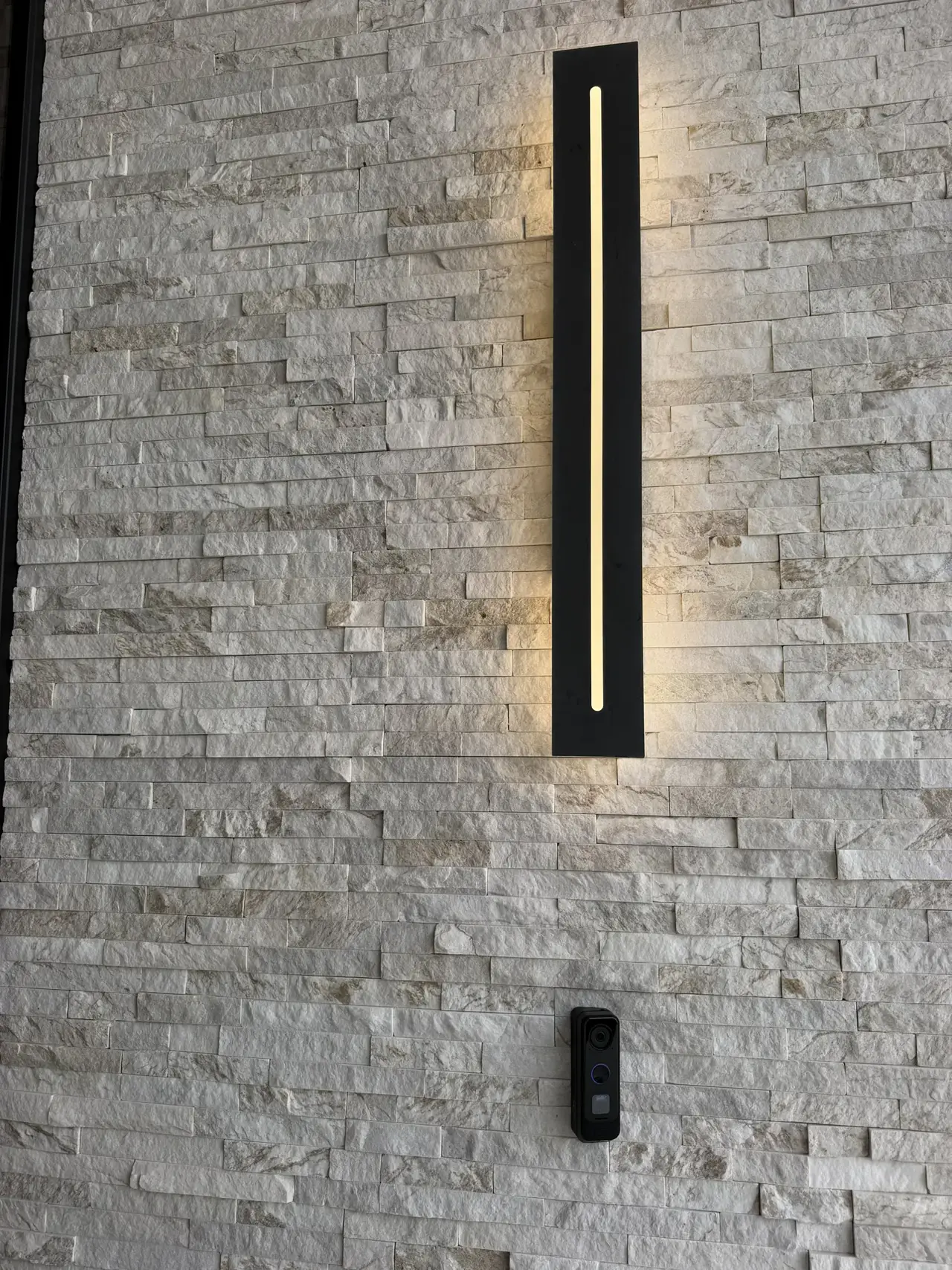 Exterior sconce on stacked stone by CZR Electric