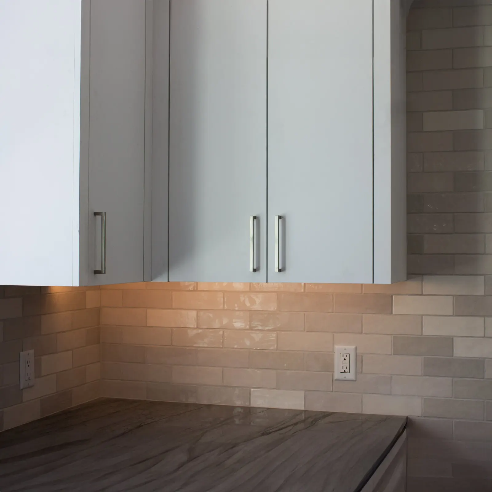 Under cabinet LED lighting washing a kitchen counter
